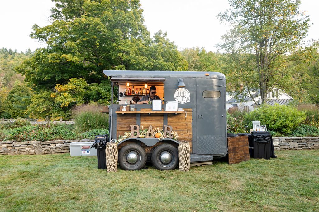 The Club Car mobile bar trailer set up outdoors in daylight