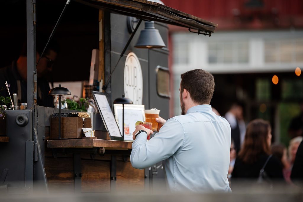 Bartender pouring a signature cocktail at the Club Car bar