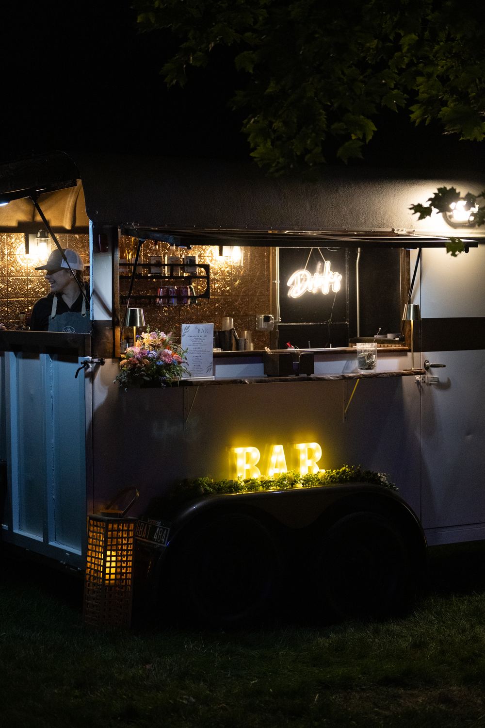 The Parlor Car mobile bar lit up in the evening