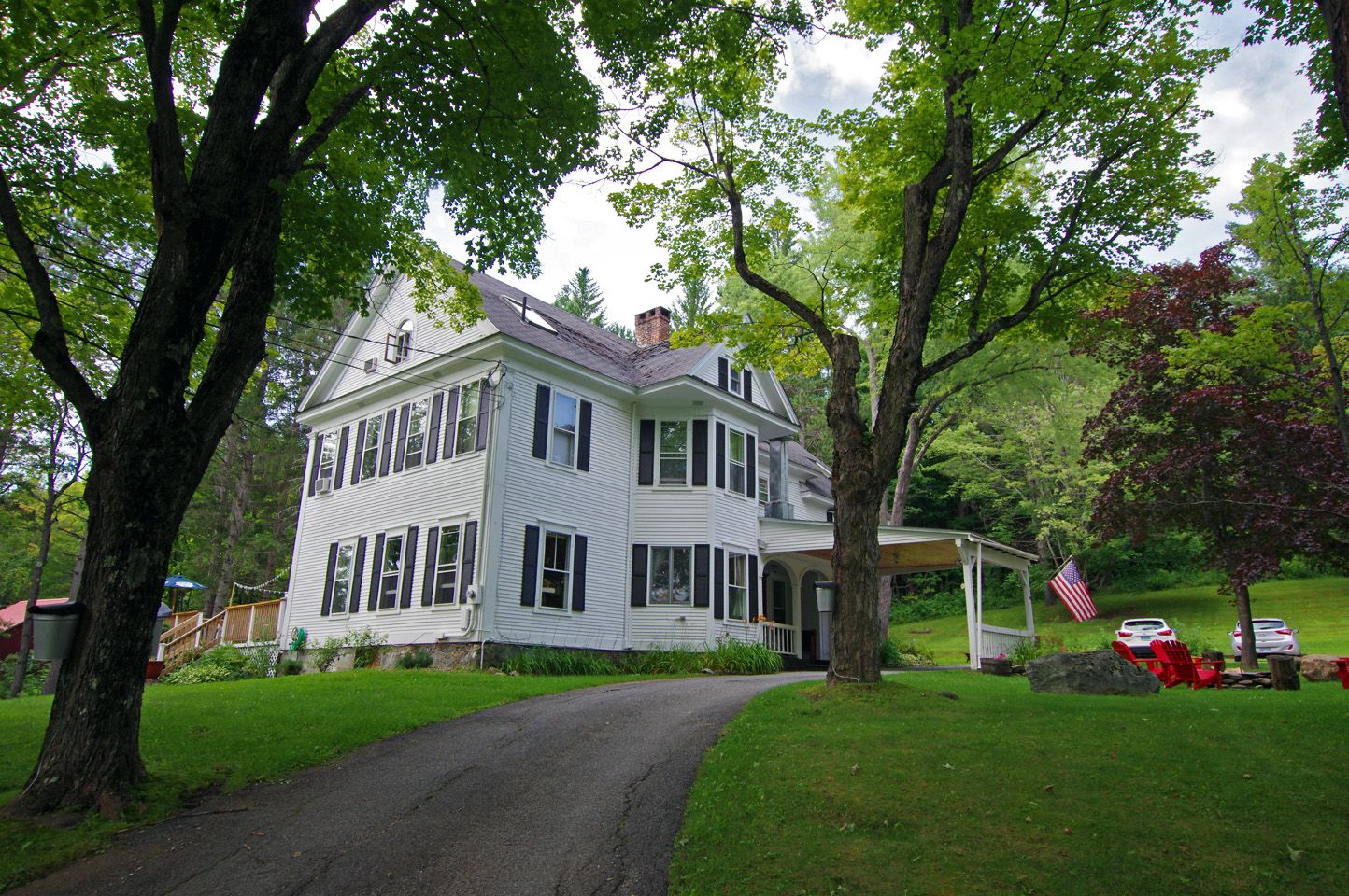 The Wilmington Inn, a white 1894 mansion surrounded by trees